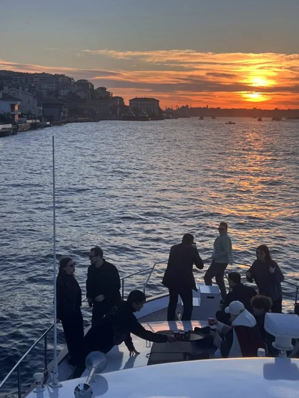 Guests enjoying the spacious aft deck during a sunset cruise