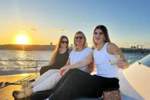 Three guests enjoying golden hour on the Bosphorus sunset group cruise