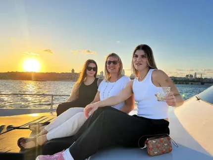 Three guests enjoying golden hour on the Bosphorus sunset group cruise