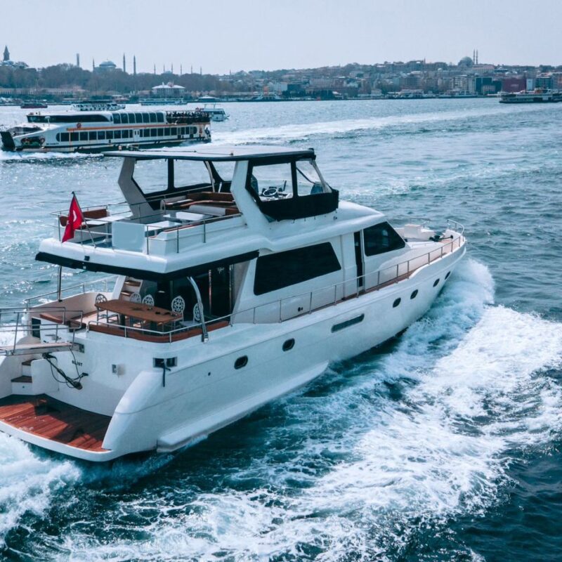 Constantine yacht cruising the Bosphorus with the city behind