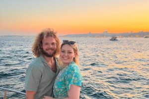 Couple embracing at golden hour on the bow of a private yacht in Istanbul