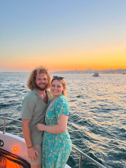 Couple embracing at golden hour on the bow of a private yacht in Istanbul