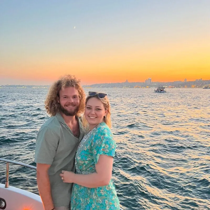 Couple embracing at golden hour on the bow of a private yacht in Istanbul