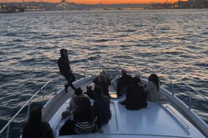 Friends enjoying golden hour on the foredeck of a private Bosphorus yacht