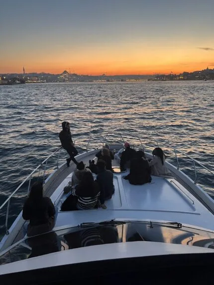 Friends enjoying golden hour on the foredeck of a private Bosphorus yacht