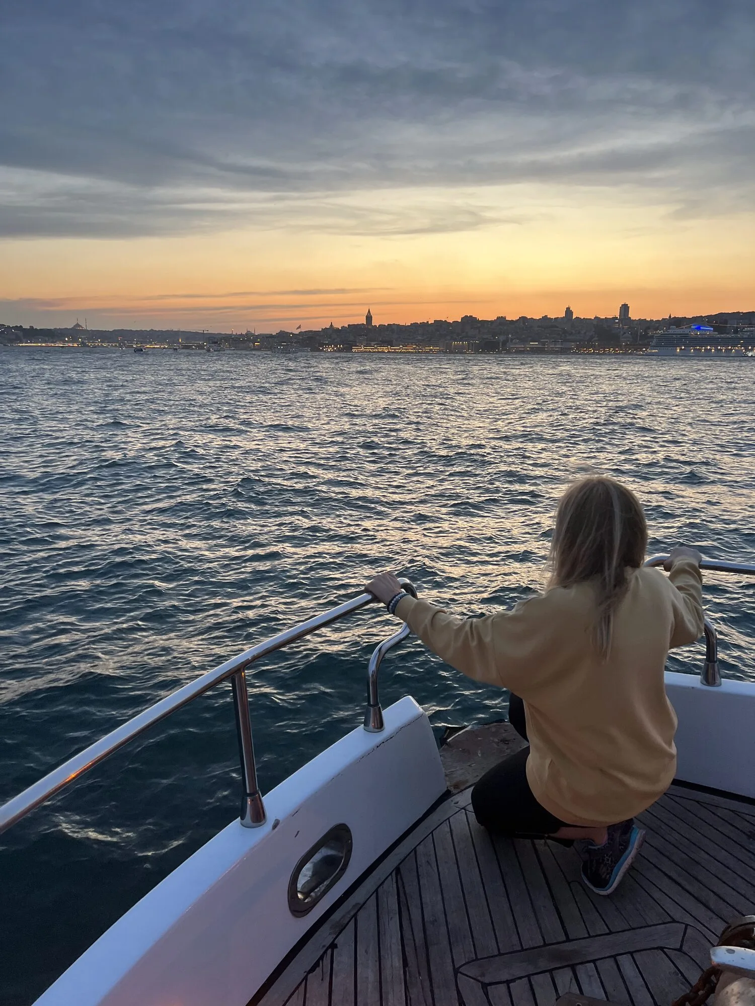 Guest enjoying golden hour on the bow of a private yacht in Istanbul