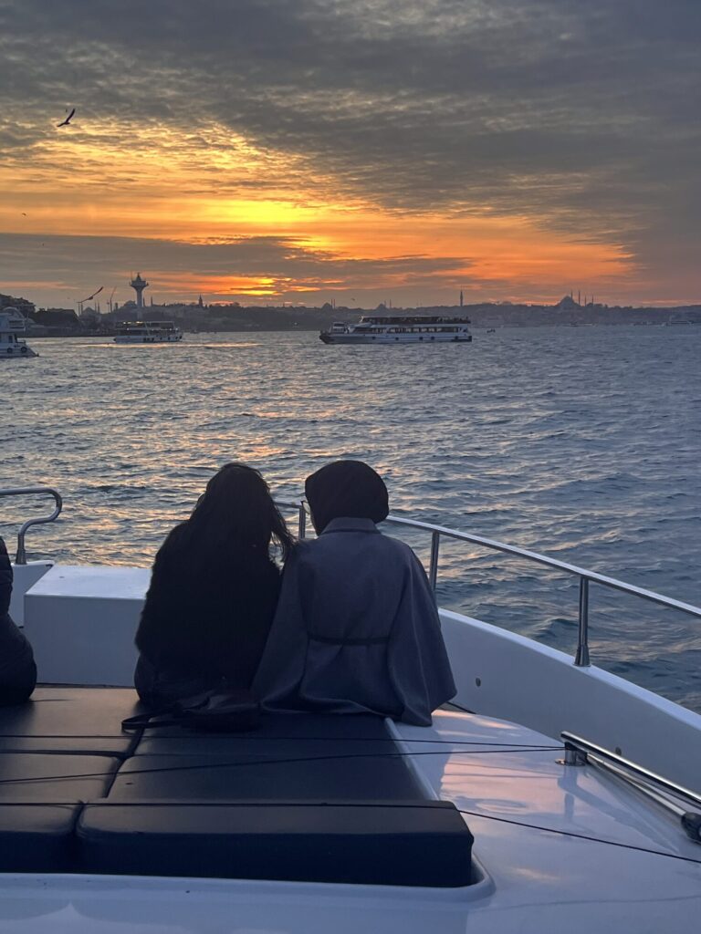 Guests watching the sunset from the yacht foredeck on the Bosphorus