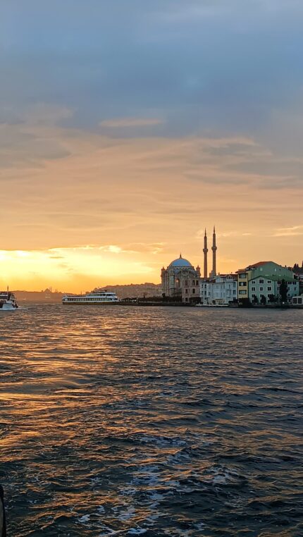 Ortakoy Mosque at sunset seen from a yacht on the Bosphorus