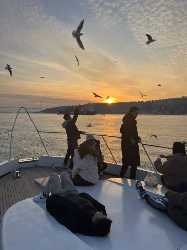 Guests on deck in golden hour light on the northern Bosphorus