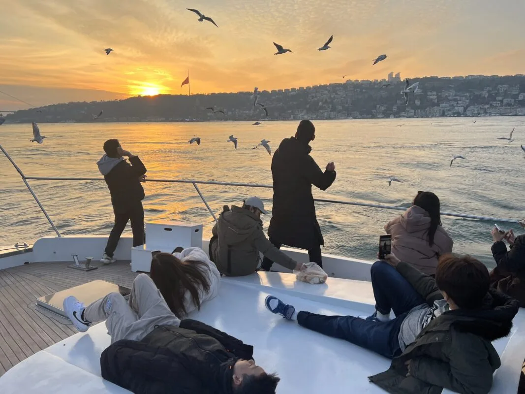 Guests on a Constantine Yachts deck watching the Istanbul shoreline on the way to the Princes Islands