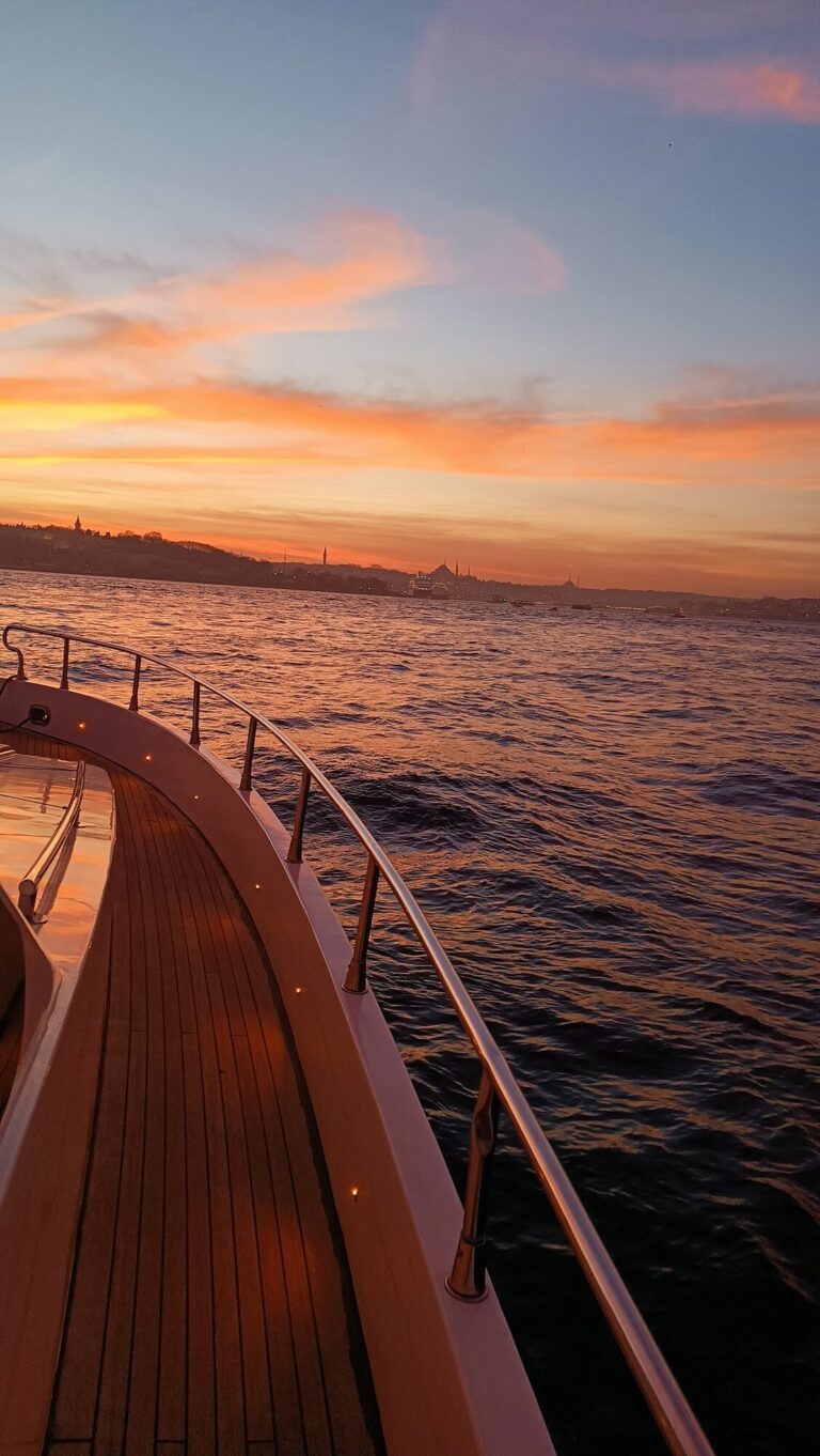 Teak deck curve of a luxury yacht under the sunset light