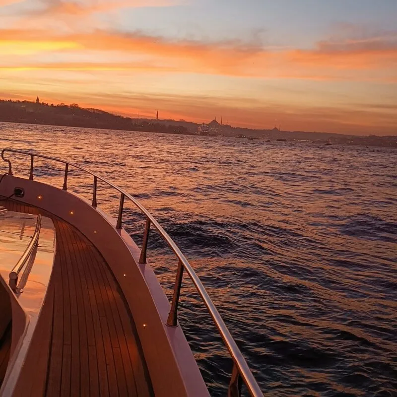 Teak deck curve of a luxury yacht under the sunset light