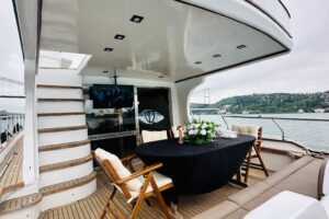 Dinner table set on the Tuana yacht deck, Bosphorus behind