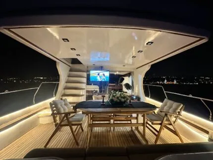 Tuana yacht saloon at night with table set for guests