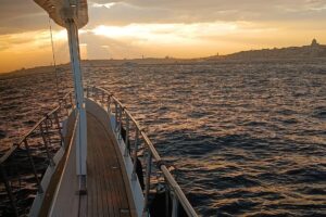 Teak side deck of a luxury yacht with the sunset over the Bosphorus