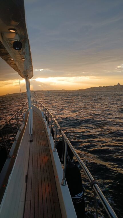 Teak side deck of a luxury yacht with the sunset over the Bosphorus
