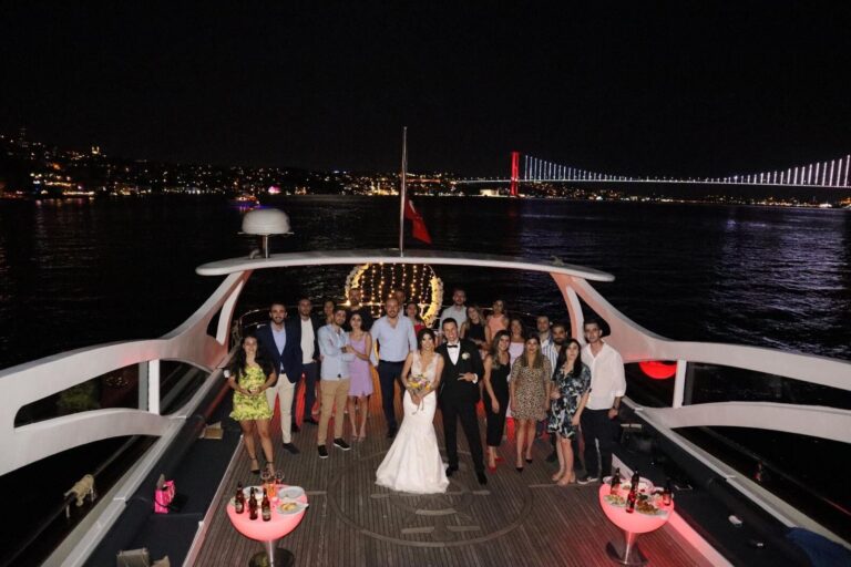 Night wedding on the yacht deck with the Bosphorus Bridge illuminated behind